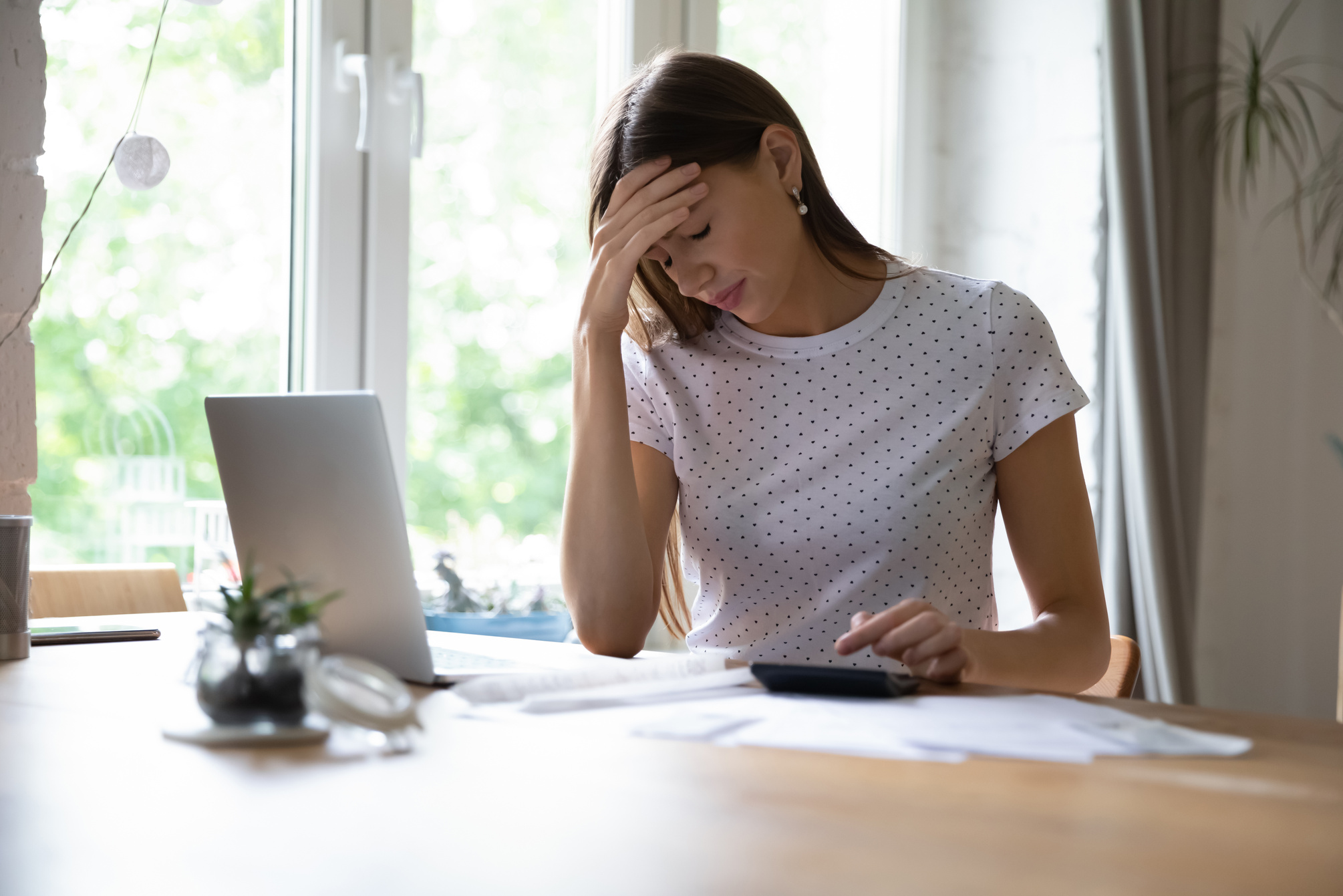 Frustrated young woman distressed by financial budget problems